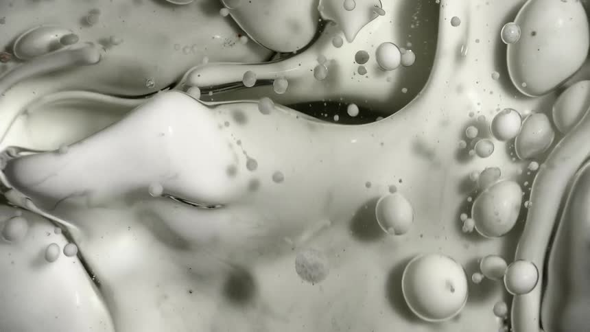 Abstract monochrome white colors rotating in water and oil