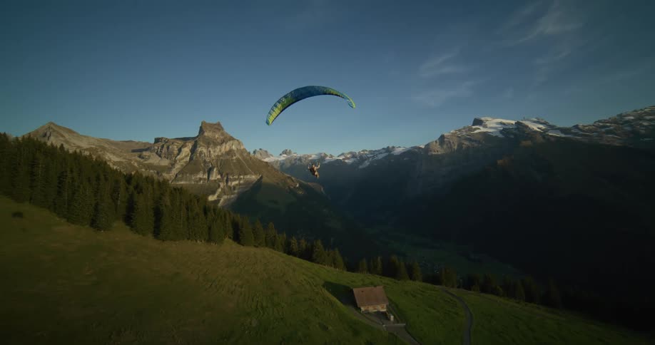 Aerial view of a paraglider over the mountains