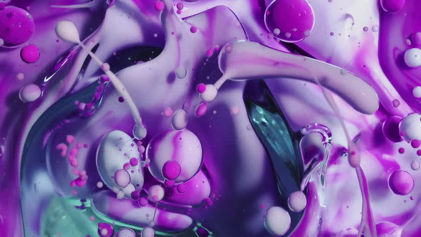 Swirling abstract pink colors mixing in oil bubbles
