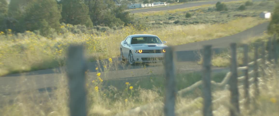 White sports car driving in the countryside
