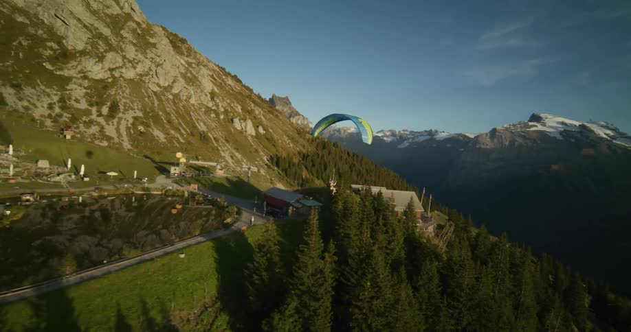 A person is paragliding off the mountain
