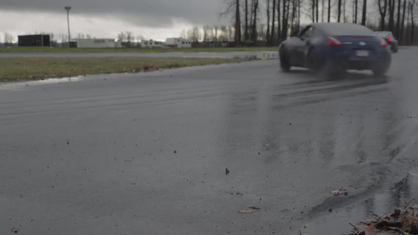 Cars traveling at high speed on a rainsoaked street