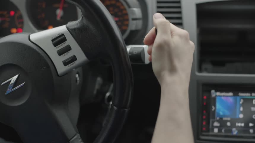A person driving a car turning the steering wheel