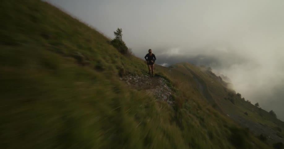 Two people are running on top of a hill