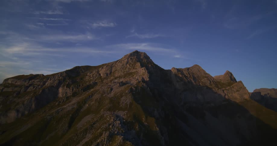 A big mountain of rocks and the sky is very blue
