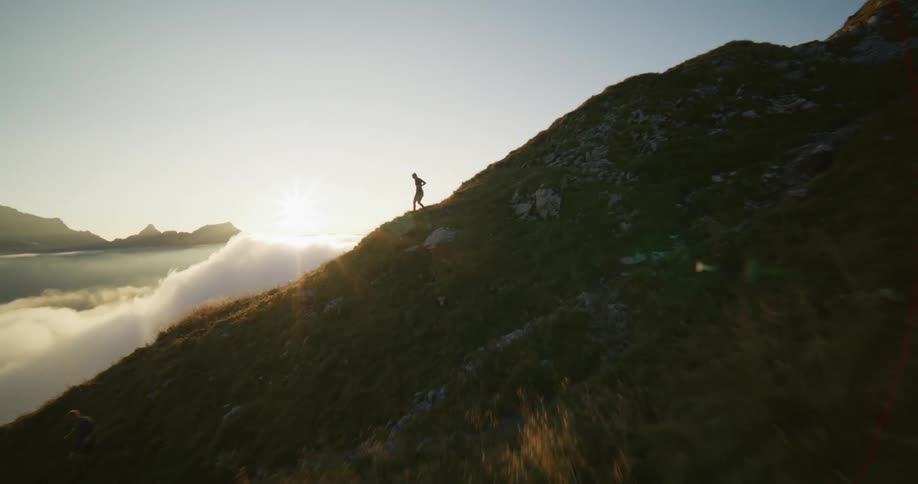A woman running down the side of a mountain