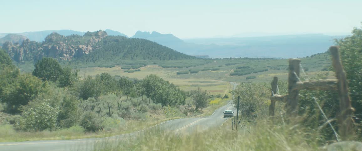 A dodge car diving in top speed in the country side