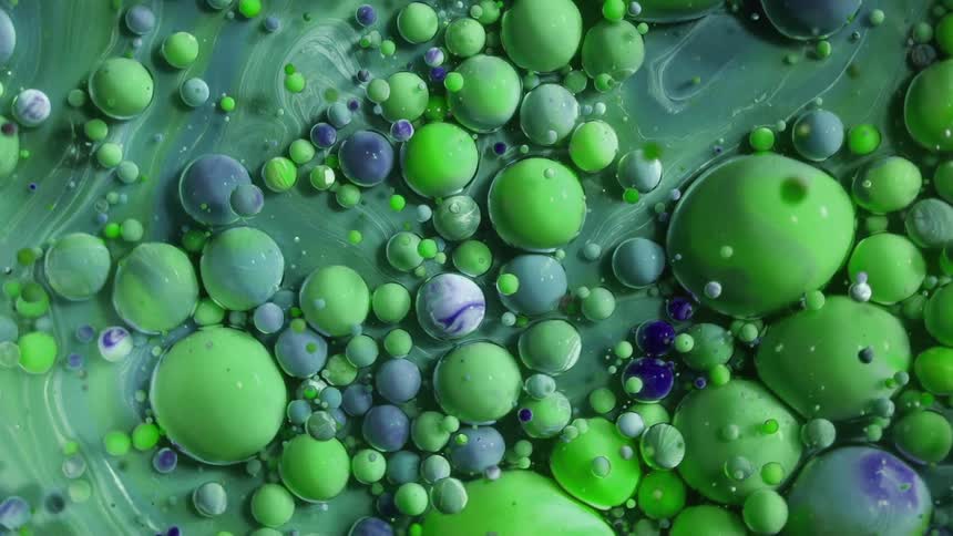 Rotating abstract green color bubbles in oil and water