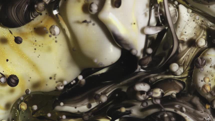 Golden liquid colors floating in abstract underwater bubbles
