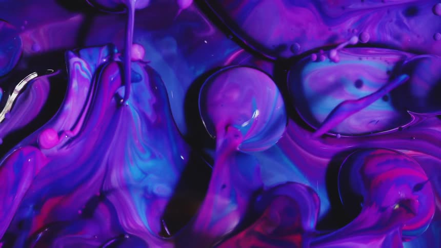 Pink and blue inks forming abstract underwater bubbles