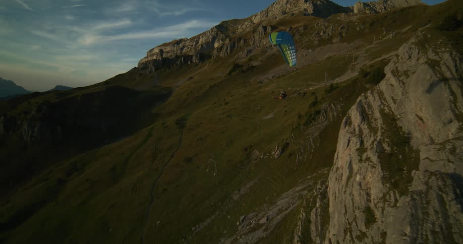 A person parachuting in a mountainous region