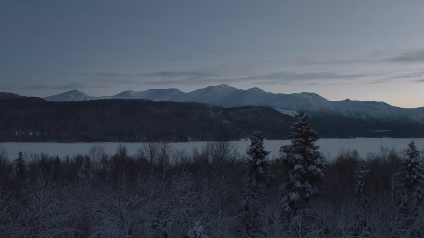 A calm lake at the edge of a mountain range