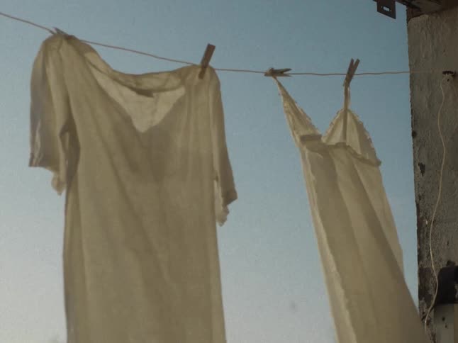 Two women clothes hanged on a line to sun dry