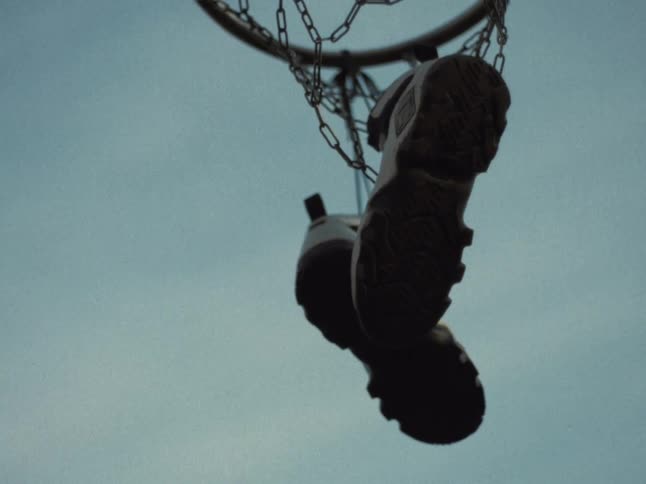 A pair of sneakers hanging from chains