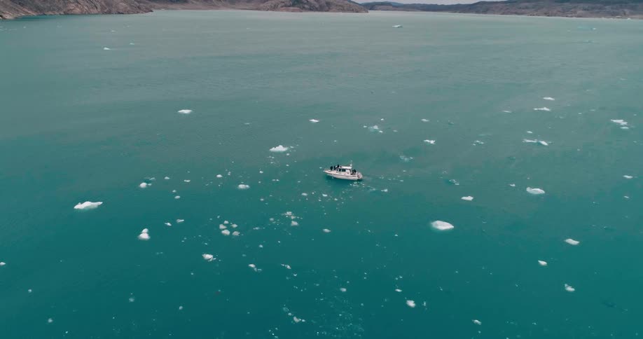 Aerial view of a boat floating in the arctic ocean