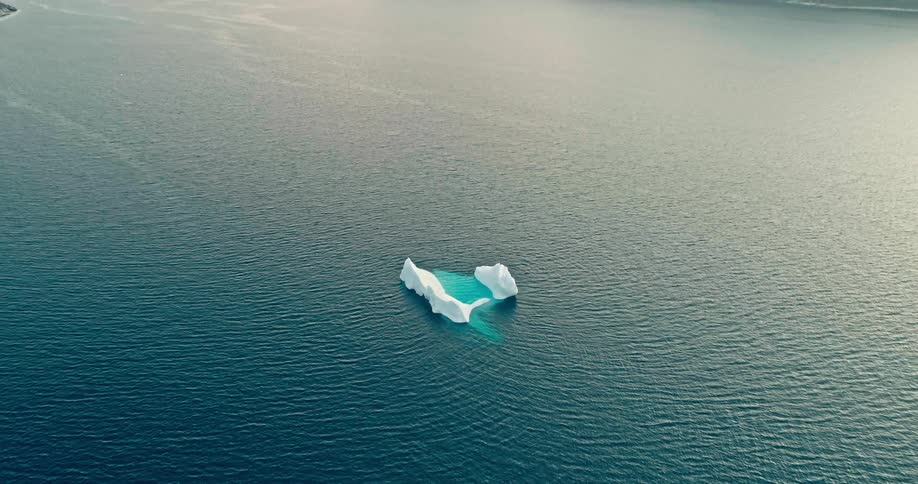 Aerial view of an iceberg floating in the sea