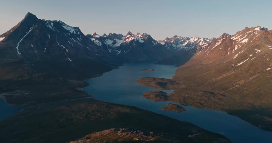 Landscape of a central lake surrounded by mountain ranges covered in snow on a morning