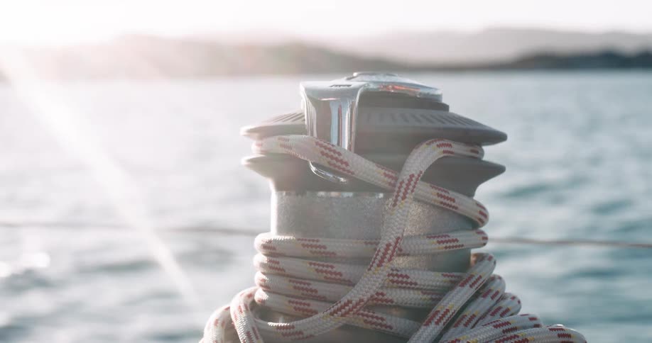 A winch with a rope wound around it on a boat
