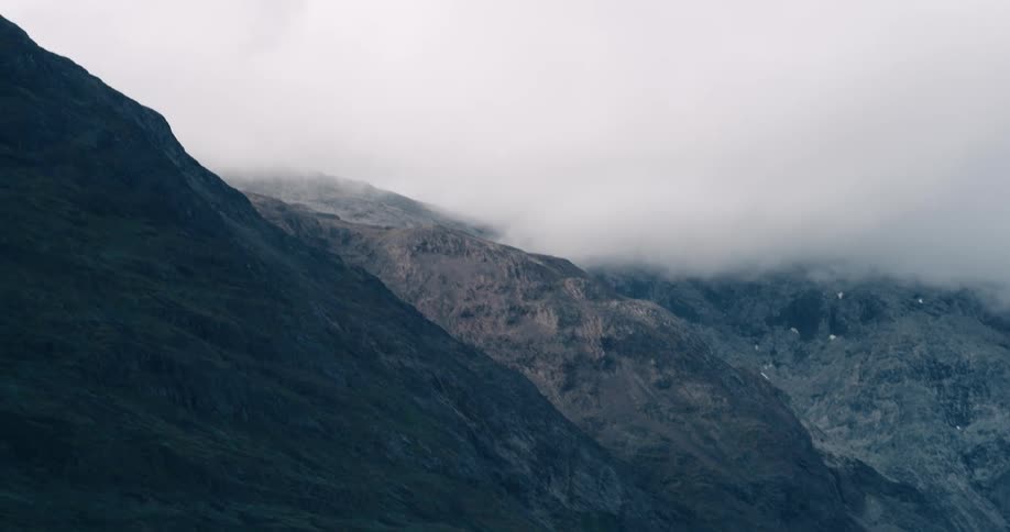 Aerial of a mountain peak covered by clouds