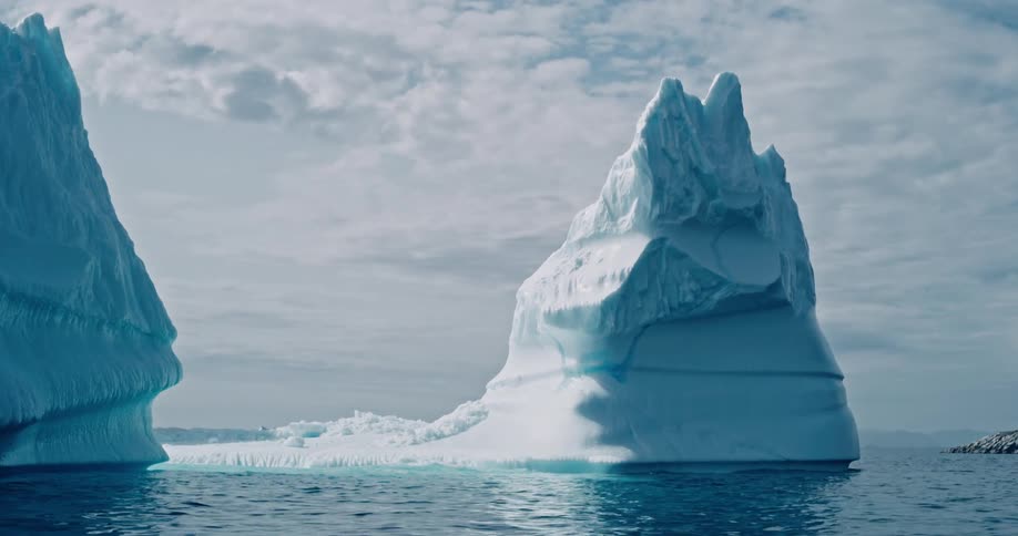Icebergs in the midst of the sea on a cloudy day