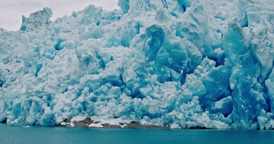 Blue ice wall of a glacier in the arctic coastline