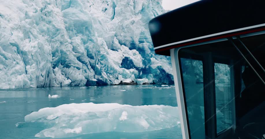 A boat travels past the ice