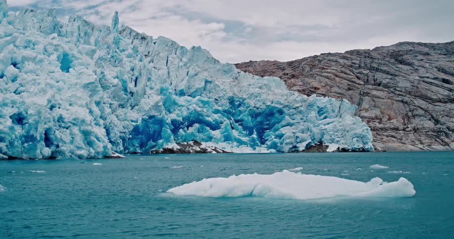 Icebergs floating next to a glacier in the coast