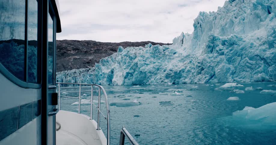View from inside the boat sailing through icy waters on a partly cloudy day