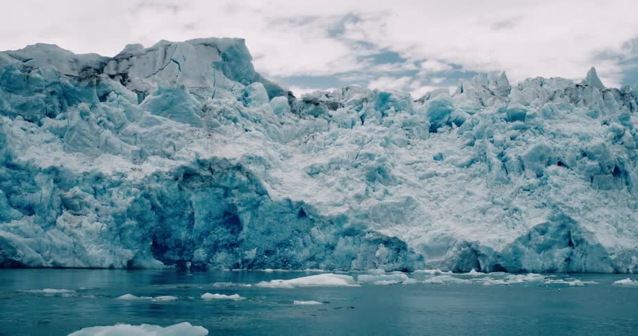 Seagulls fly over melting ice floating off the arctic coast