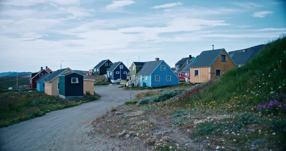 Colorful houses in the midst of a village beneath the mountains