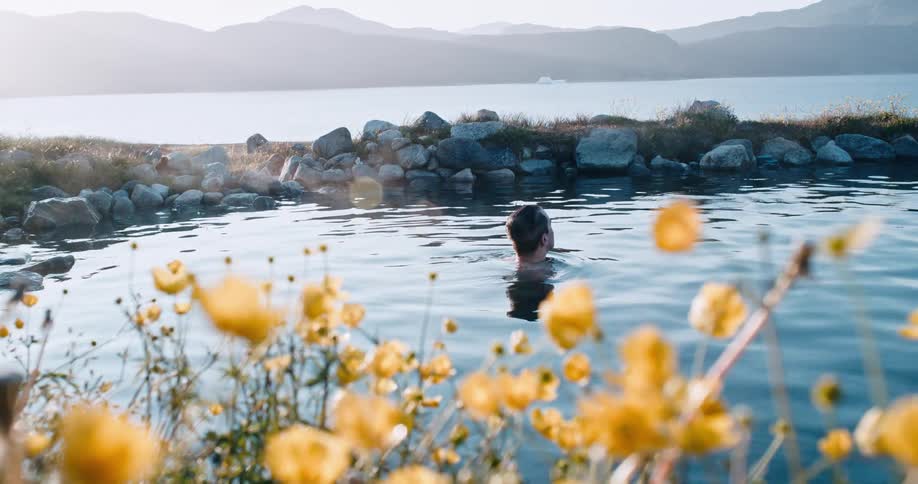 Man takes a bath on a pond near a lake