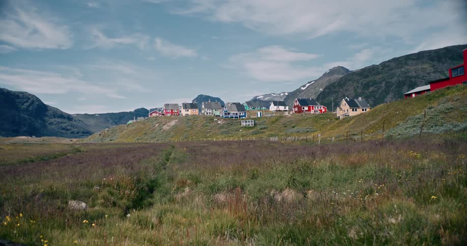 A small village with few buildings close to the mountain