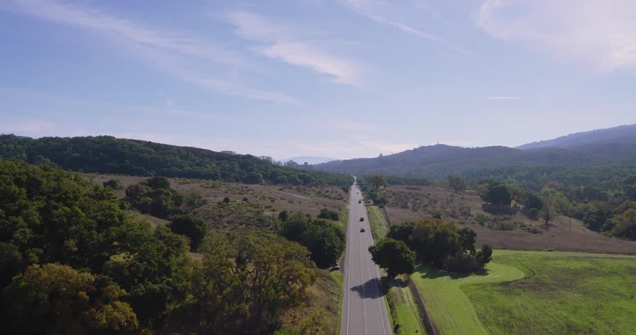 Aerial of cars driving on a highway in the field