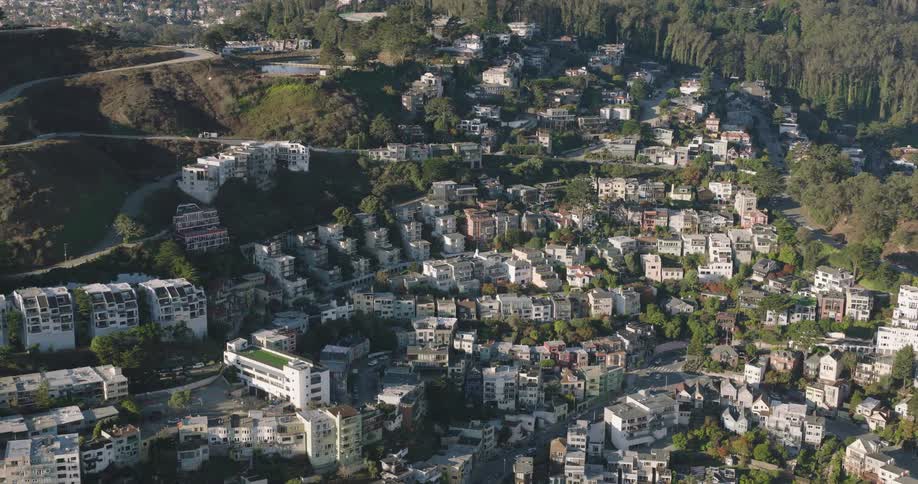 Aerial view of a hillside community with white houses along a winding road in san francisco during the day