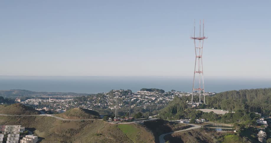 Aerial panorama of residential houses nestled among mountains with a tower