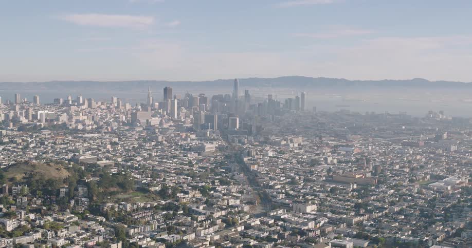Aerial view of suburban areas and distant tall buildings in the city