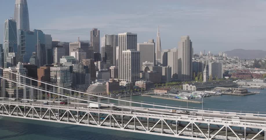 An aerial clip of a citys connecting bridge on the sea