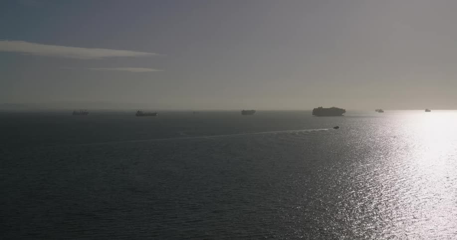 View of the ocean with fleets of boats on the horizon