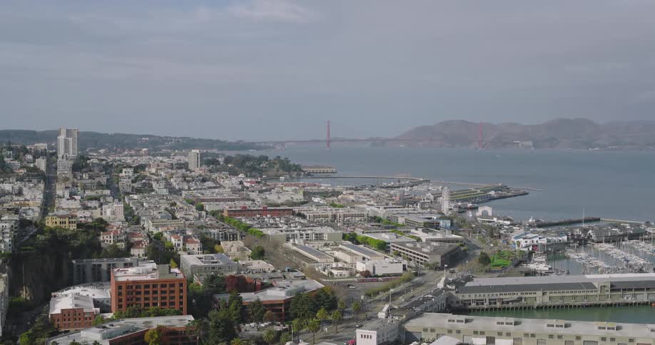 An aerial view of a large seaside city in the daytime