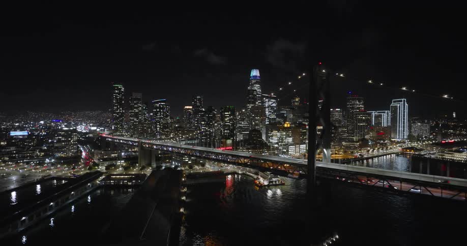 Traffic travels over the bridge at night