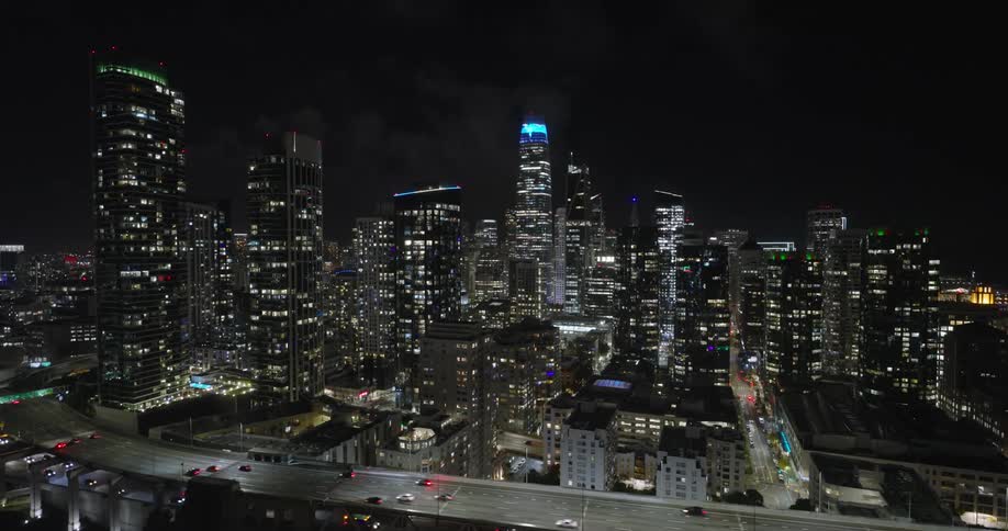 Traffic runs on the freeway by the city at night