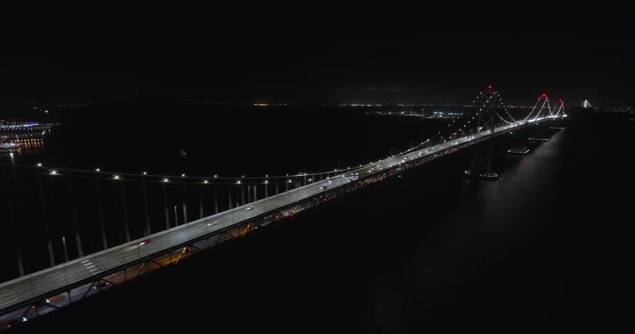 Aerial view traffic on a bridge near the city at night