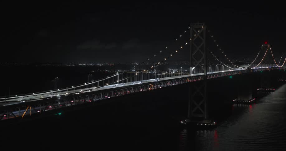 Traffic runs over the bridge at night