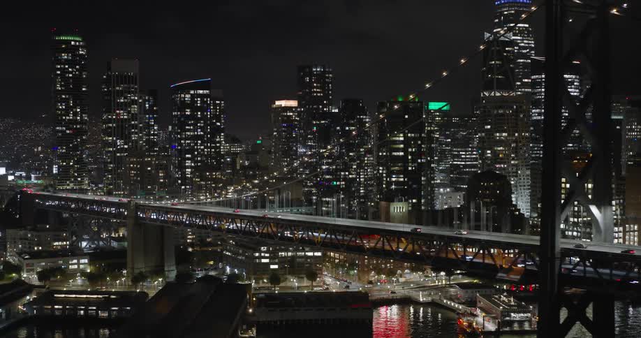 Aerial of bridge over urban city during illuminated night