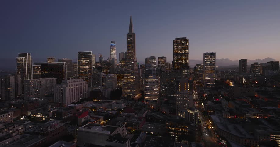 Aerial view of a city skyline with a bluepink sky at dusk