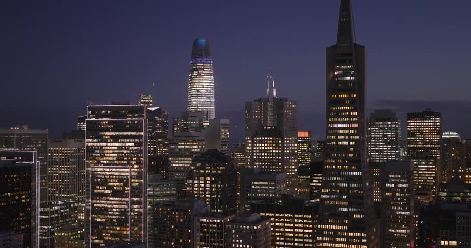 Lights on metropolitan buildings and towers glow in the darkness