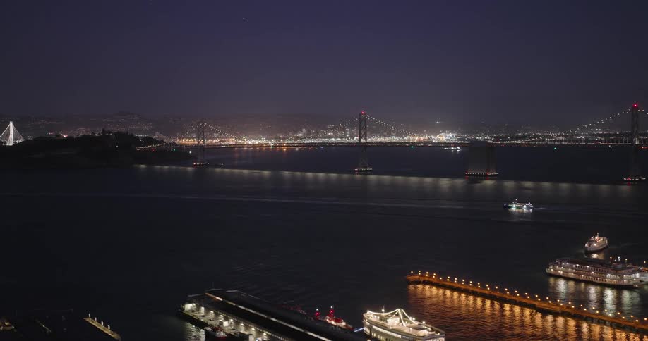 A boat is traveling under the bridge