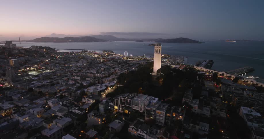 Aerial panorama of an urban city with houses and apartments by the seaside under a purple dawn sky