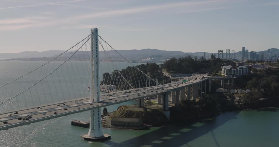 Vehicles crossing the bridge towards the urban city