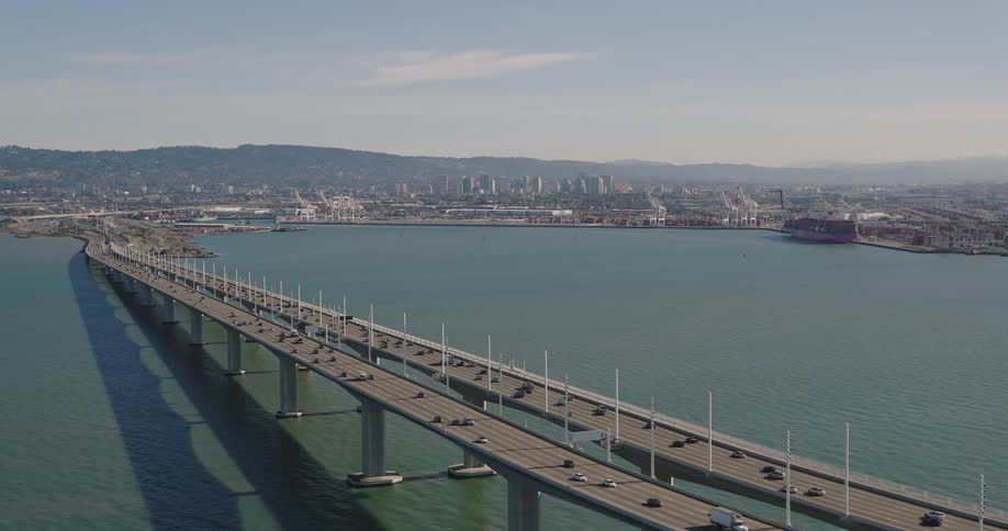 Aerial of the bridge over the sea crossing the urban city